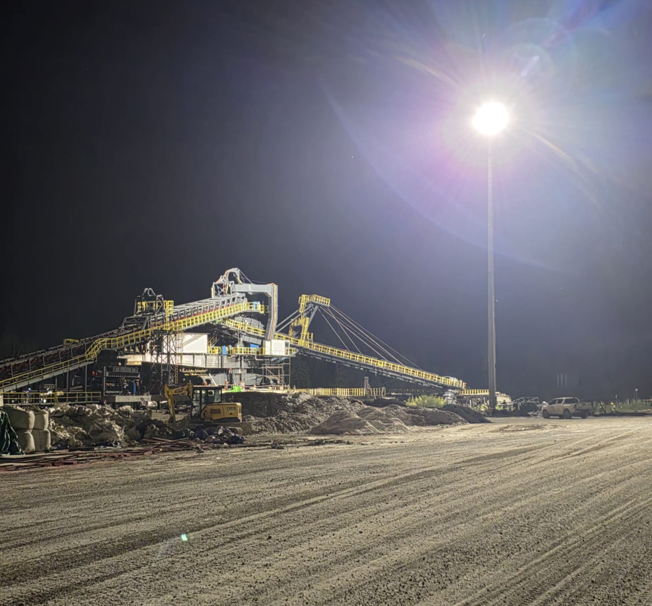 ULTRA 600W LED high mast lights being installed by crane at the mining site.